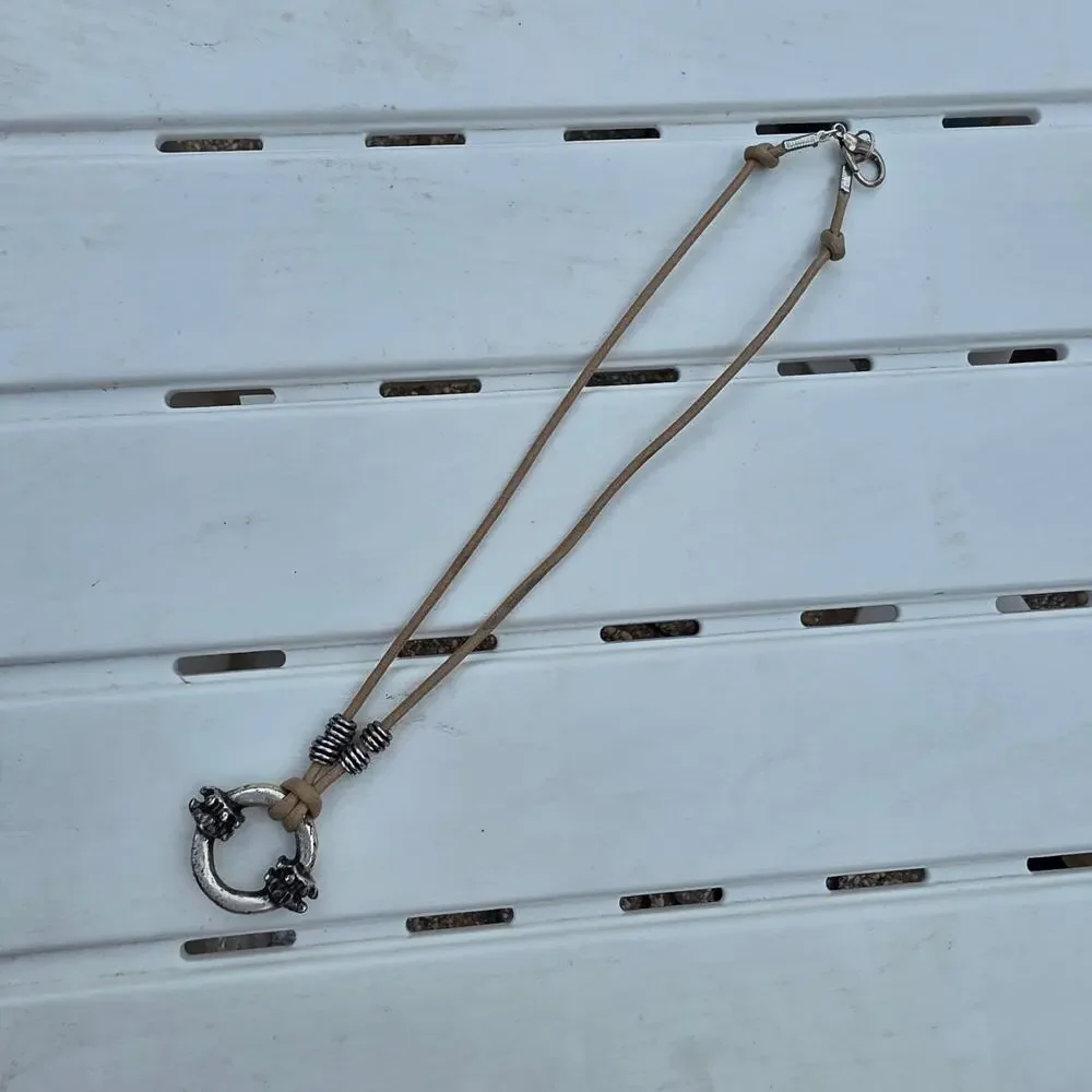 beige leather cord necklace with a silver-tone ring pendant